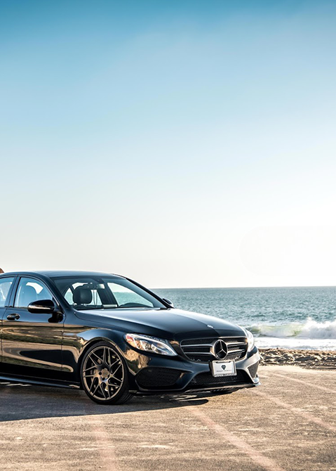 Mercedes car with ocean waves in the background