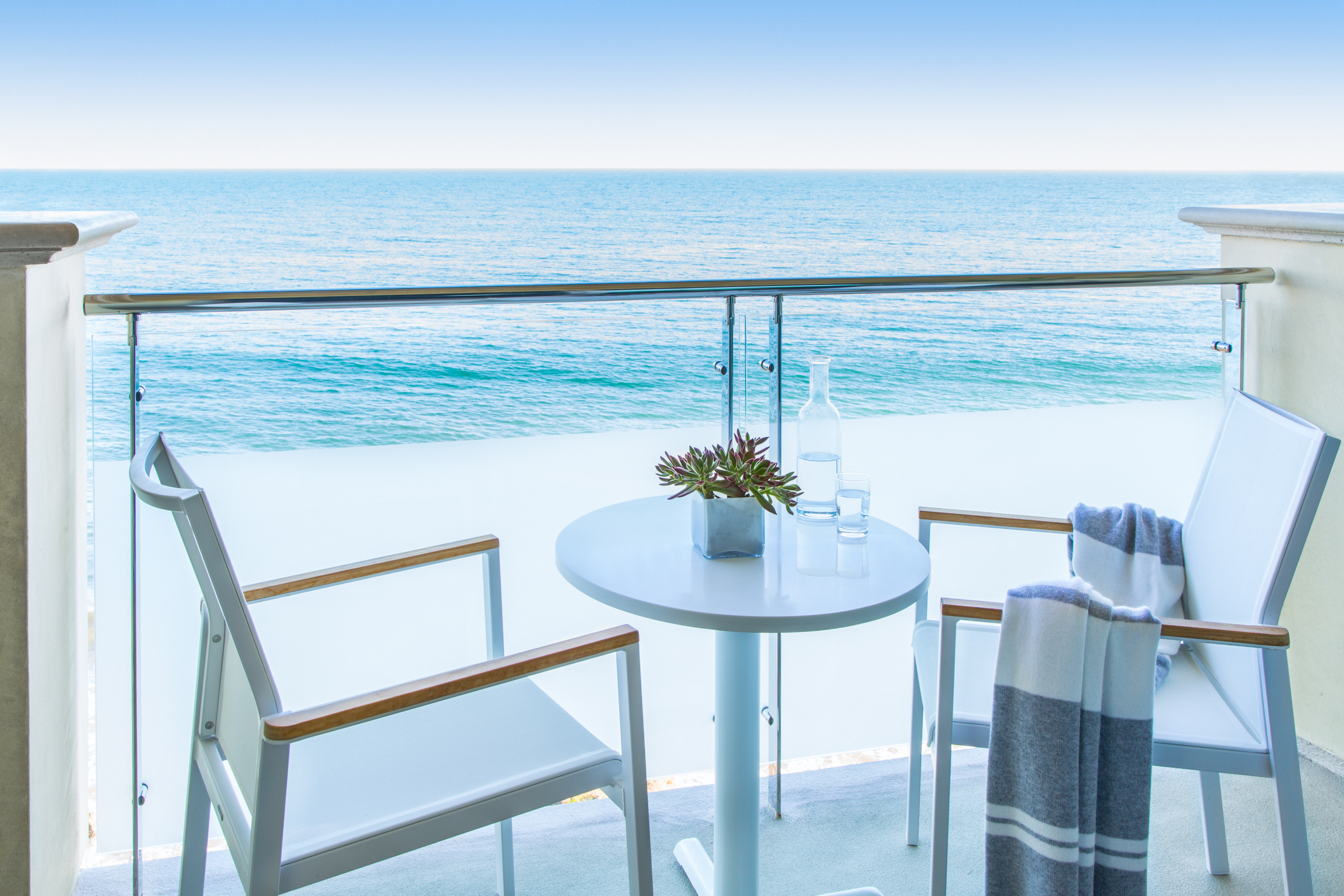balcony view with two chairs and table