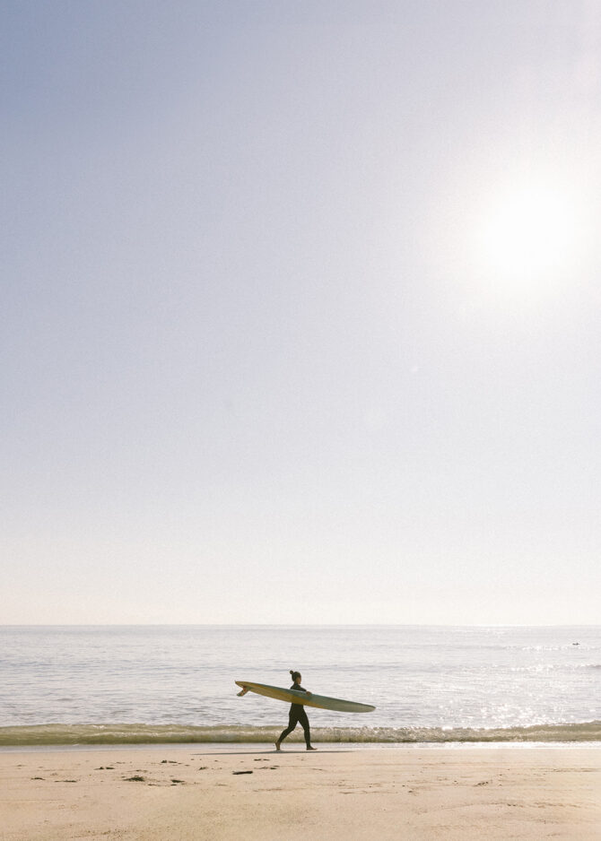 man with surfer board at beach