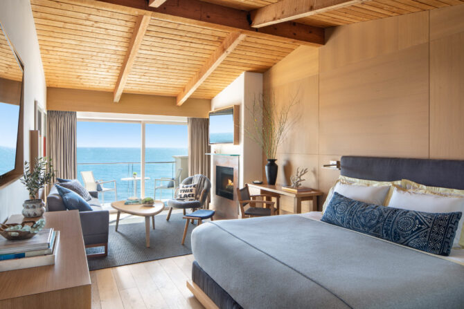 bedroom with ocean view and fireplace