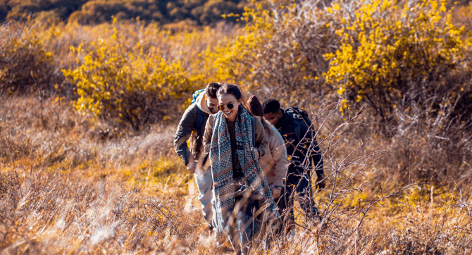 Friends hiking in the fall, one of the best things to do in Malibu this season.