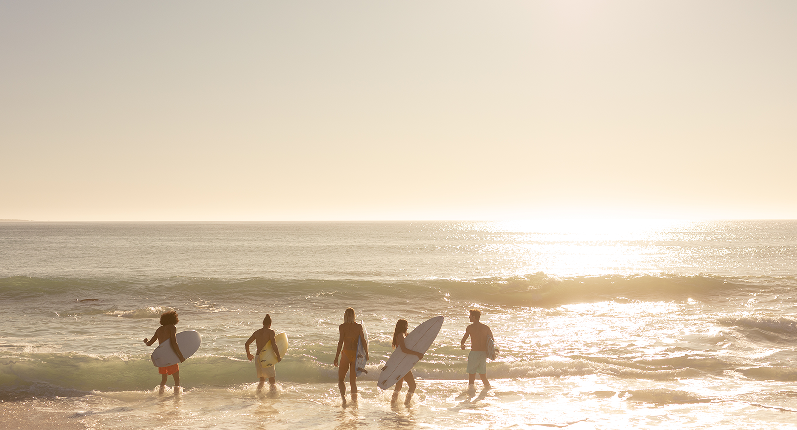 A group of surfers in Malibu at sunrise