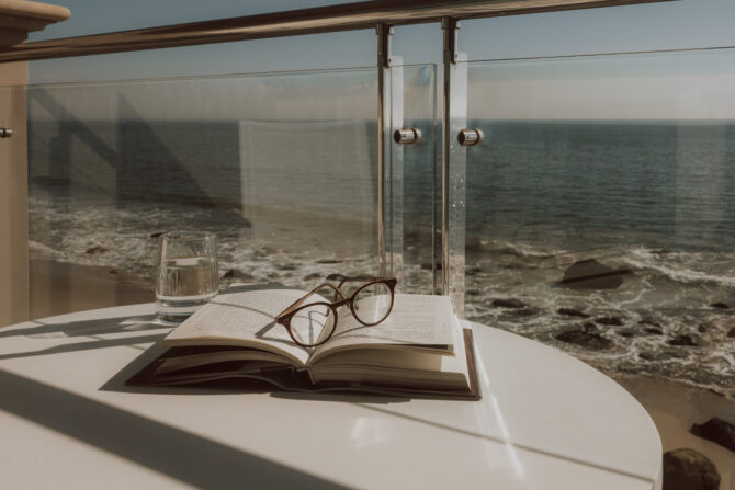 book and glasses on table for air mail package