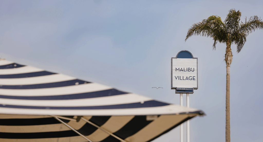 view of the Malibu village sign near the beach