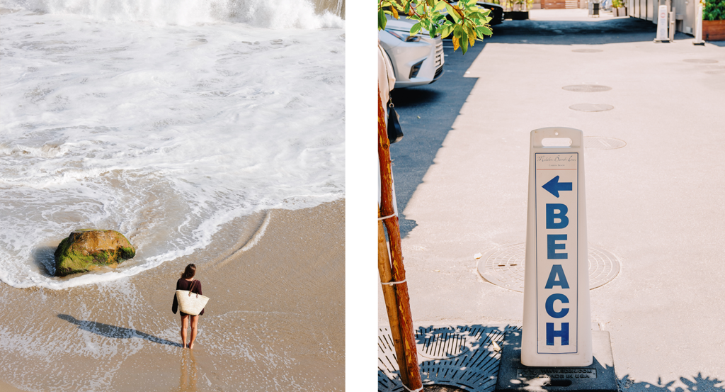 A woman walking on the beach and a blue and white beach sign