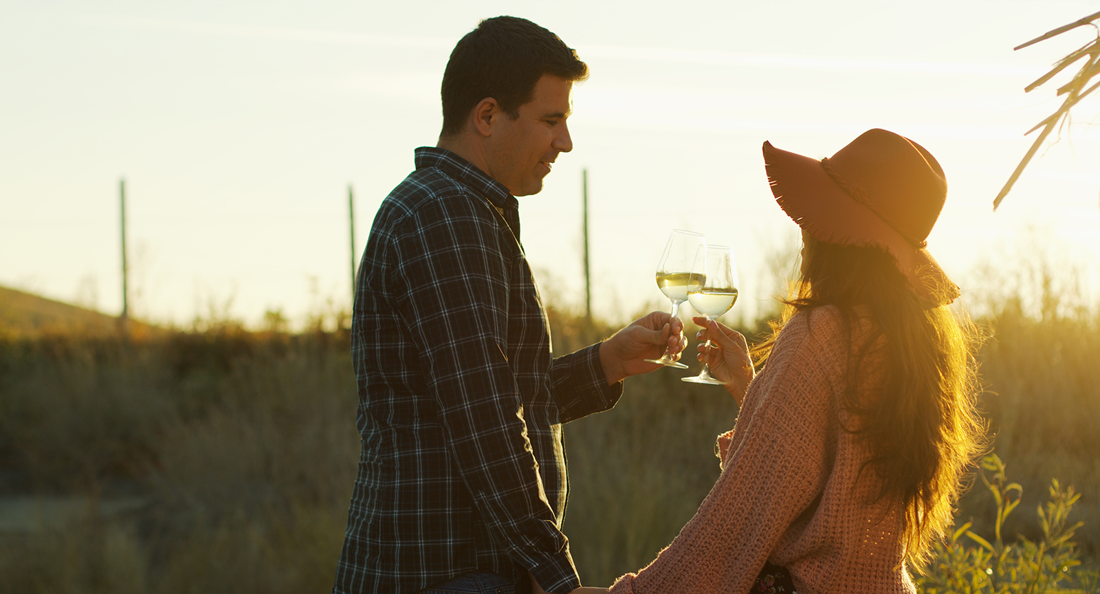 A couple holding hands while Malibu wine tasting